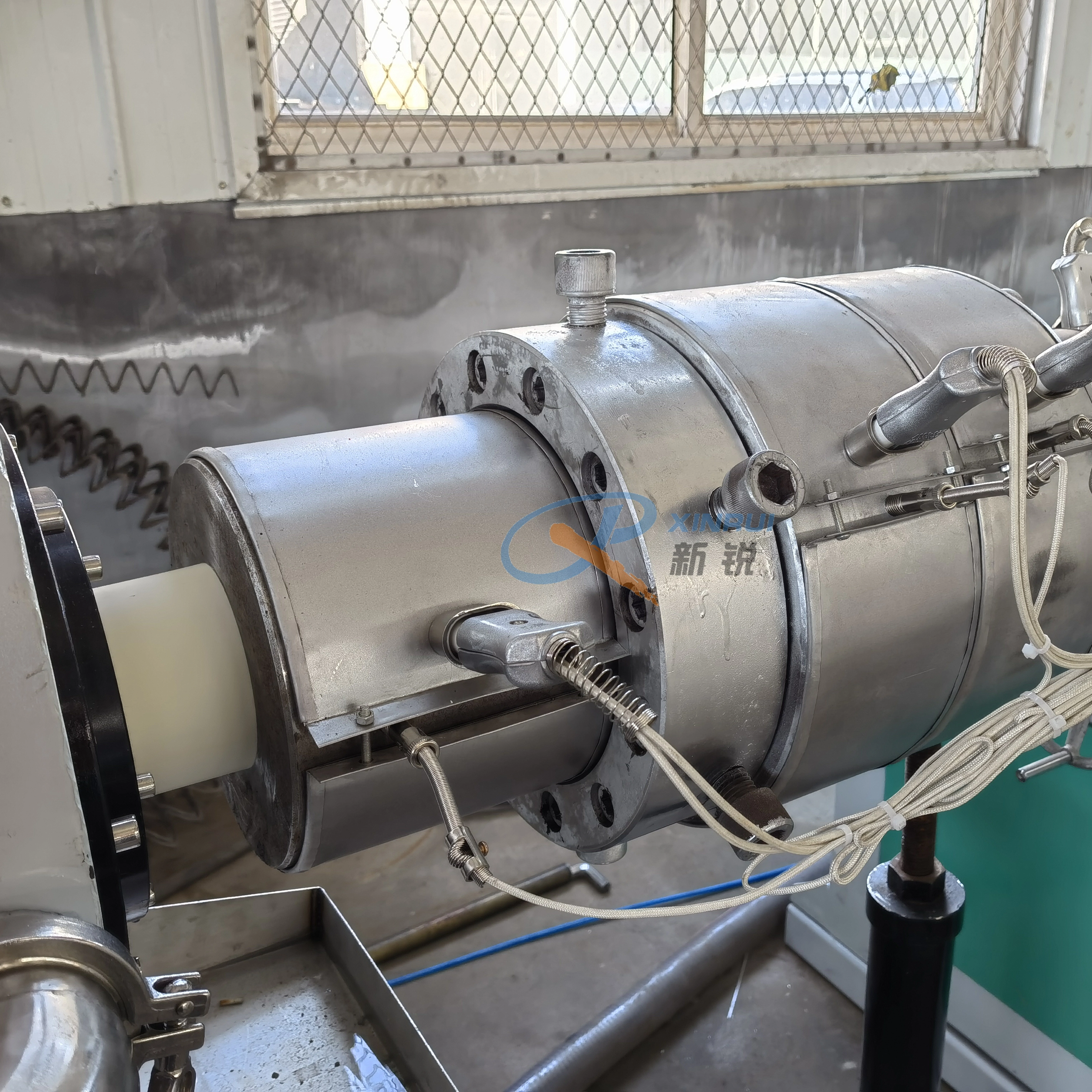 Commercial plastic pipe extrusion machine setup in a manufacturing facility